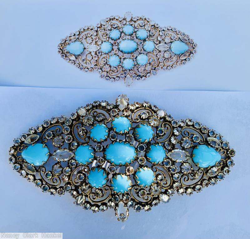 Schreiner diamond shaped radial scrollwork buckle bordered small invert stone oval cab center 8 surrounding round cab 2 large teardrop at end opaque baby blue round cab crystal inverted goldtone jewelry