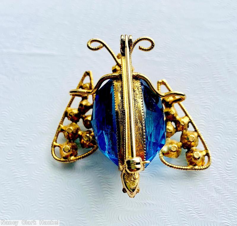 Schreiner 2 wired wing large oval stone body bug 6 small chaton on wave decorated back bar 3 eye 7 varied size chaton in wing curly antenna clear champagne small chaton peking glass small chaton topaz small chaton eye large faceted ice blue faceted stone goldtone jewelry
