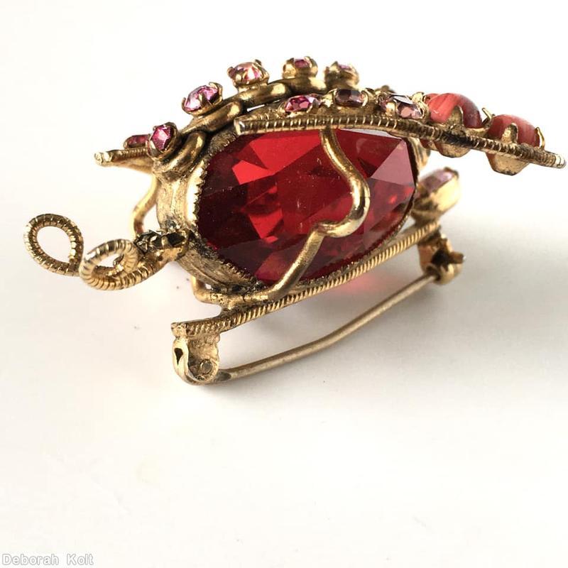Schreiner 2 wired wing large oval stone body bug 6 small chaton on wave decorated back bar 3 eye 7 varied size chaton in wing curly antenna ruby large faceted oval stone pink small chaton marbled coral small chaton jet small chaton goldtone jewelry