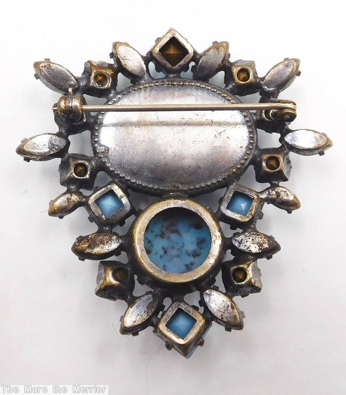 Schreiner bilateral symmetrical pin large oval stone center large round cab bottom surrounding mix of small square stone navette turquoise clear aqua opaque aqua silvertone jewelry