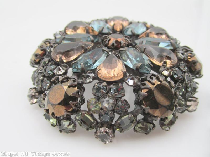 Schreiner hexagonal domed radial concave flat top pin small chaton center 6 surrounding navette 6 round stone on side wall smoky blue smoky topaz metalic brown crystal pale green jewelry