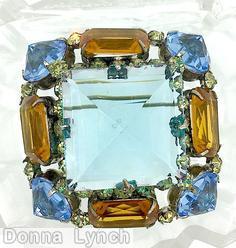 Schreiner large square center domed square pin 4 pointy corner stone 4 emerald cut side large faceted square stone topaz emerald cut pale blue large inverted stone silvertone jewelry