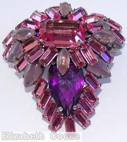 Schreiner triangle shaped 2 level domed radial pin top level large emerald cut center 12 surrounding baguette 4 navette bottom level large teardrop baguette navette wine large emerald cut purple large teardrop wine baguette moonglow lavender navette silvertone jewelry