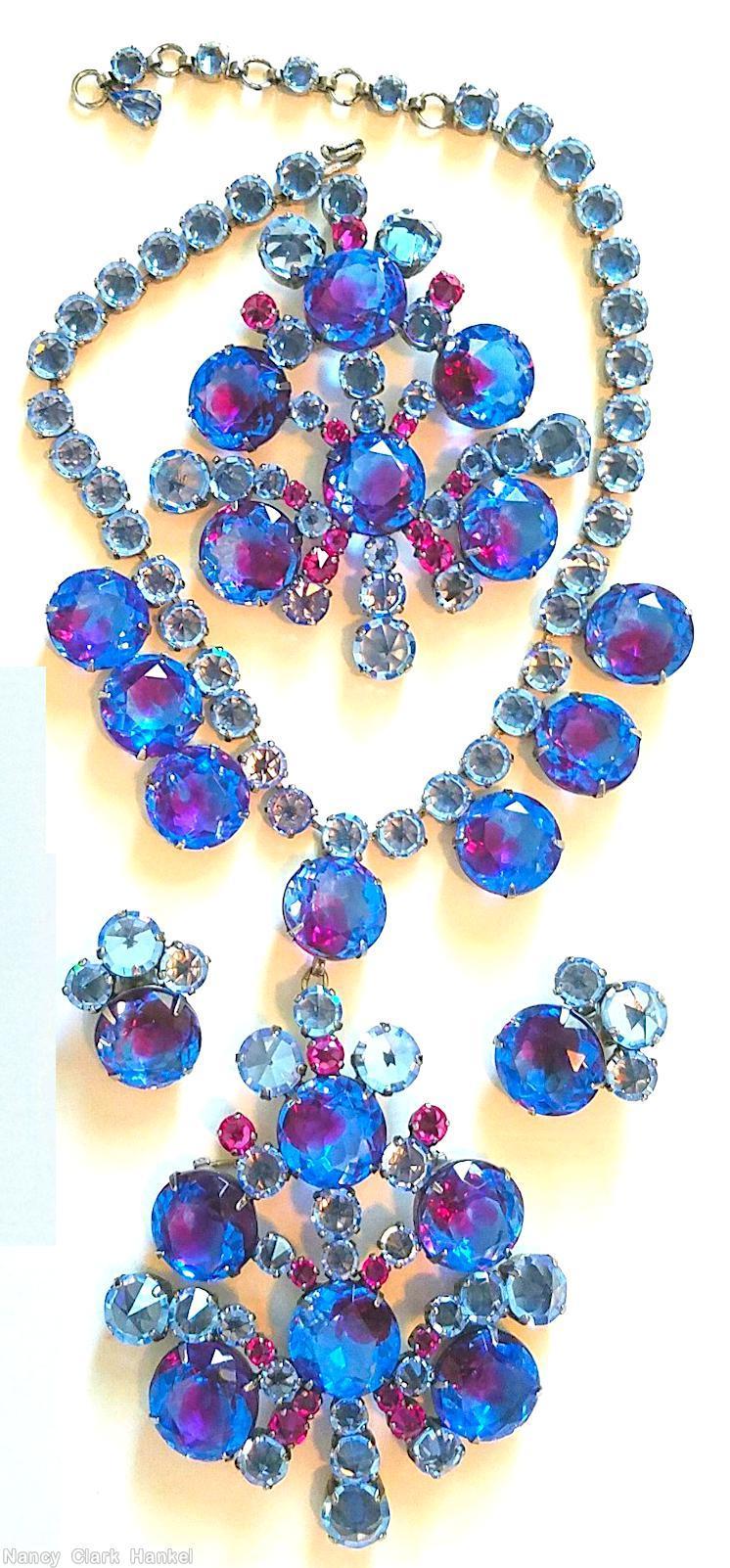 Schreiner single chain of faceted chaton with 7 drippy large faceted chaton dangling radial shield shaped pendant large faceted chaton center 6 large faceted chaton bicolor sapphire ruby ice blue jewelry