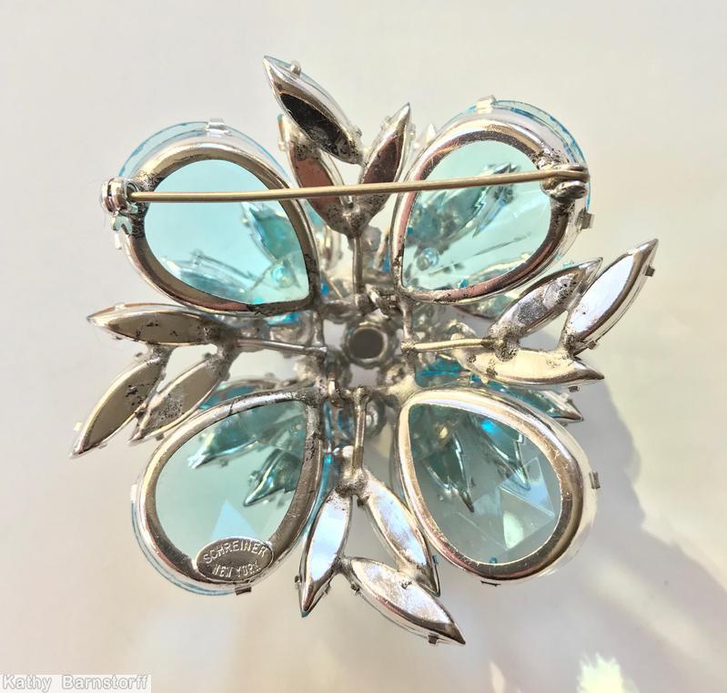 Schreiner 2 level domed square pin 4 large teardrop corner stone 9 inverted center stone random arranged navette surrounding clear aqua large teardrop fuschia chaton bicolor aqua ice blue navette jewelry