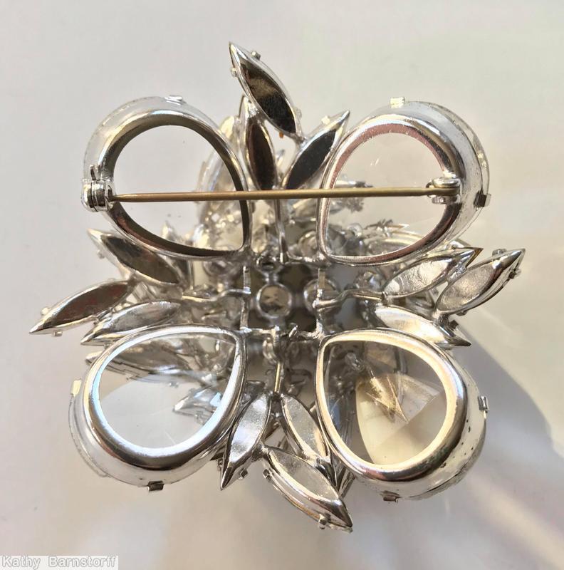 Schreiner 2 level domed square pin 4 large teardrop corner stone 9 inverted center stone random arranged navette surrounding crystal jewelry