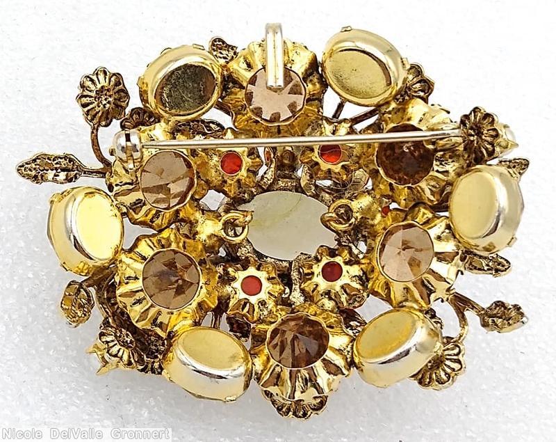 Schreiner 2 level oval radial pin 10 metal leaf flower branch large oval cab center 6 large chaton 8 surrounding small chaton brown large chaton orange small chaton faux pearl large moonglow oval cab brown large chaton goldtone jewelry