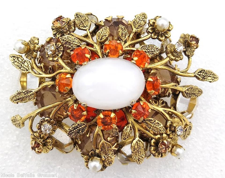 Schreiner 2 level oval radial pin 10 metal leaf flower branch large oval cab center 6 large chaton 8 surrounding small chaton brown large chaton orange small chaton faux pearl large moonglow oval cab brown large chaton goldtone jewelry