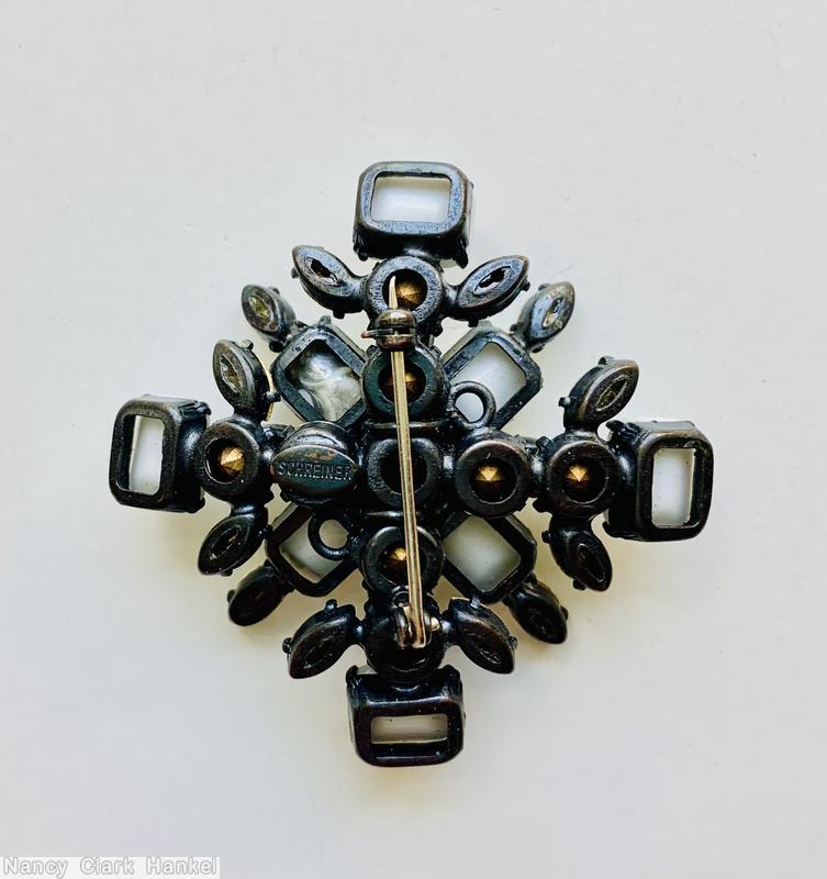 Schreiner 2 level radial cross pin top level chaton center 4 emerald cut 4 navette surrounding bottom 4 emerald cut 12 navette milk white emerald cut crystal navette gun metal back jewelry
