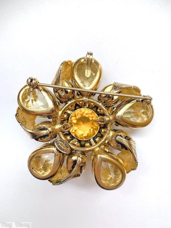 Schreiner 5 teardrop radial flower pin 10 folded metal leaf 5 small oval stone 12 surrounding stone large round center stone clear champgne large faceted teardrop green oval faceted stone amber faceted large round center faux pearl goldtone jewelry