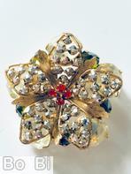 Schreiner 5 wired seeds petal radial pin 5 metal leaf red small chaton center metalic jet small chaton large champagne faceted oval stone peridot inverted stone goldtone jewelry
