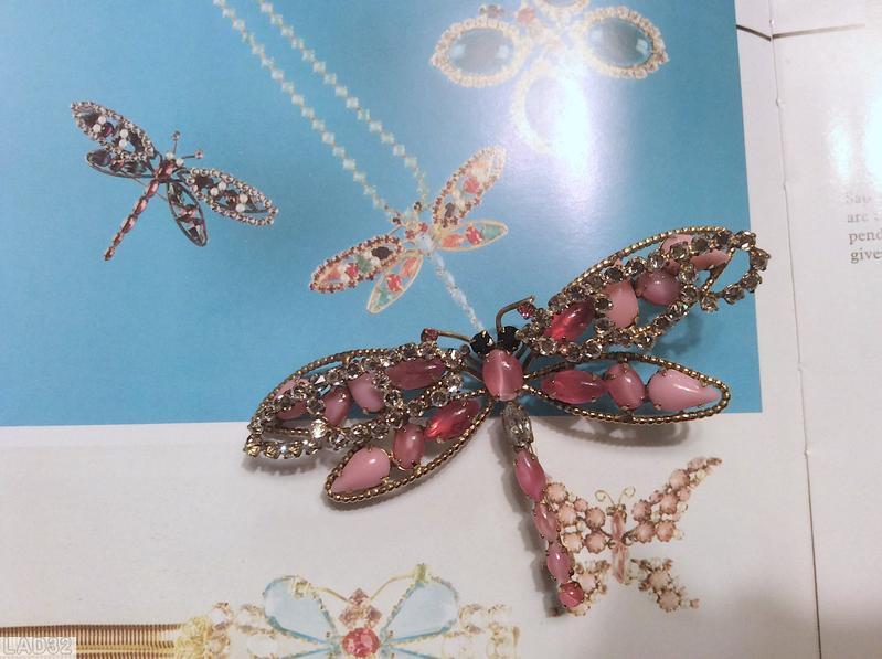 Schreiner dragonfly pin 6 varied size oval cab body 2 level wings top level 2 arched with inverted stone bottom 4 wired wing large wing 2 teardrop one oval cab one navette small wing 1 teardrop 1 oval cab 1 navette opaque pink teardrop pink jelly bean crystal small inverted stone goldtone purple small chaton jet chaton eye jewelry