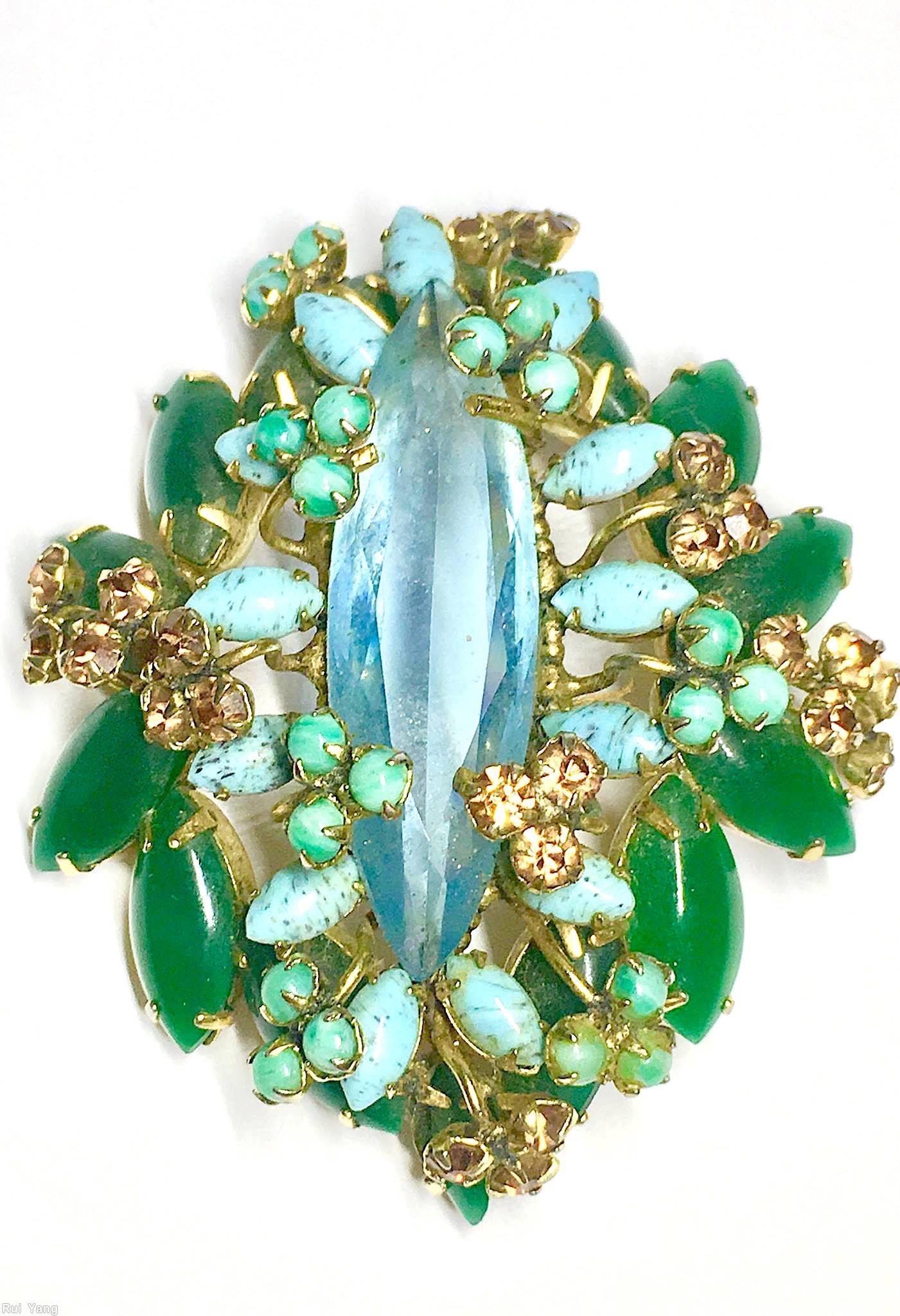 Schreiner long elongated faceted stone center stone 14 flower head 14 large navette 13 surrounding navette clear aqua center turquoise small surrounding navette emerald navette brown moonglow green goldtone jewelry