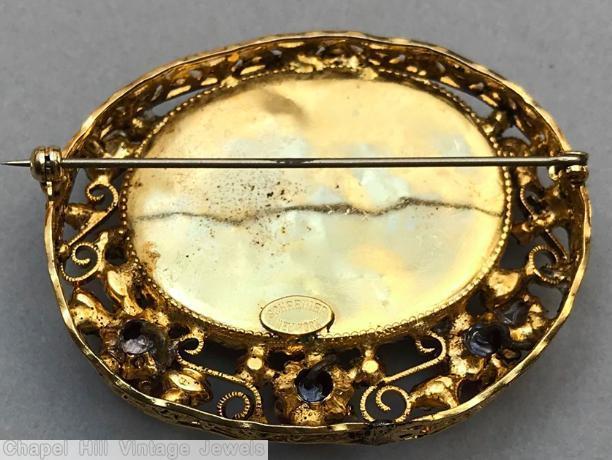 Schreiner oval shadow box pin 1 large oval stone 3 round cab 4 scrollwork speckled ruby ruby pink goldtone jewelry