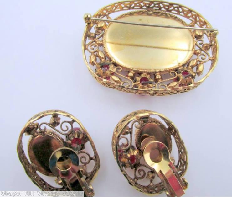 Schreiner oval shadow box pin 1 large oval stone 3 round cab 4 scrollwork speckled ruby ruby pink goldtone jewelry
