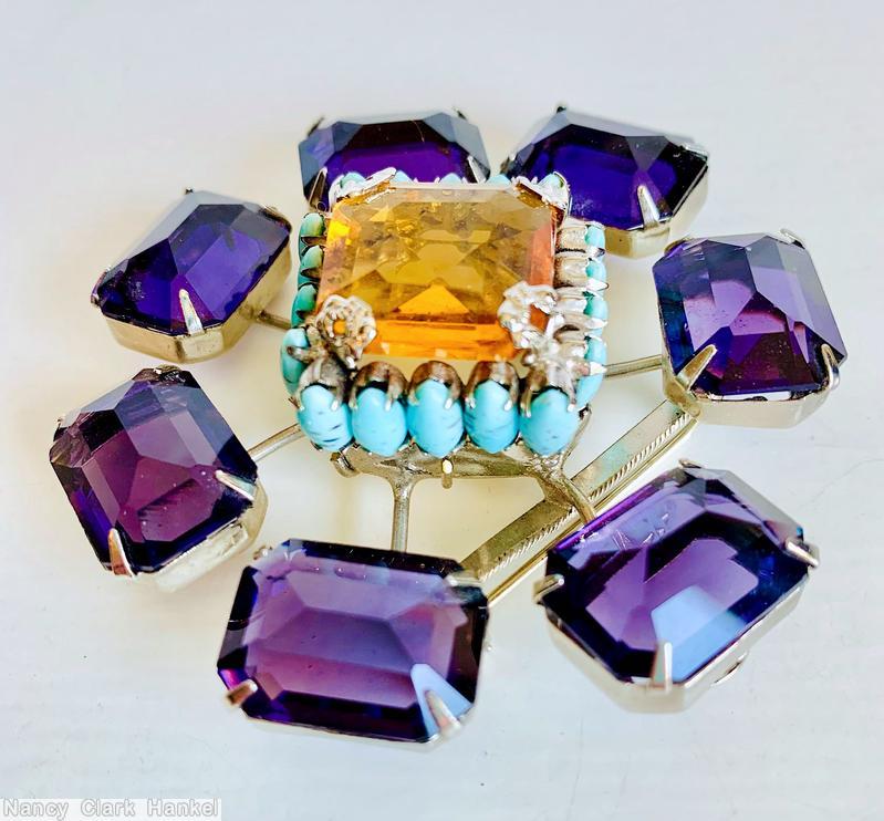 Schreiner radial 7 stem large emerald cut 1 large square faceted crystal highly domed center 18 surrounding small oval stone purple large emerald cut topaz large square faceted center turquoise small oval stone silvertone jewelry