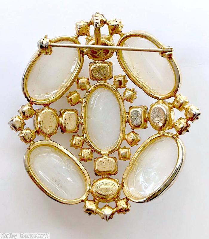 Schreiner rectangle shaped radial pin 5 large oval cab 1 center large oval stone 4 surrounding emerald cut 8 surrounding small square stone 4 small oval cab moonglow white goldtone jewelry