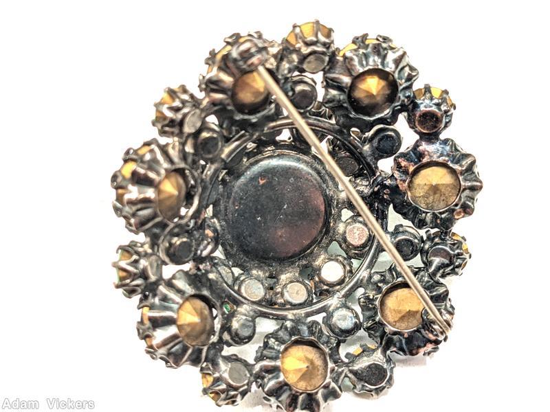Schreiner round domed pin large round cab center 12 surrounding small chaton 7 large chaton large blue cab center green small chaton blue large chaton silvertone jewelry