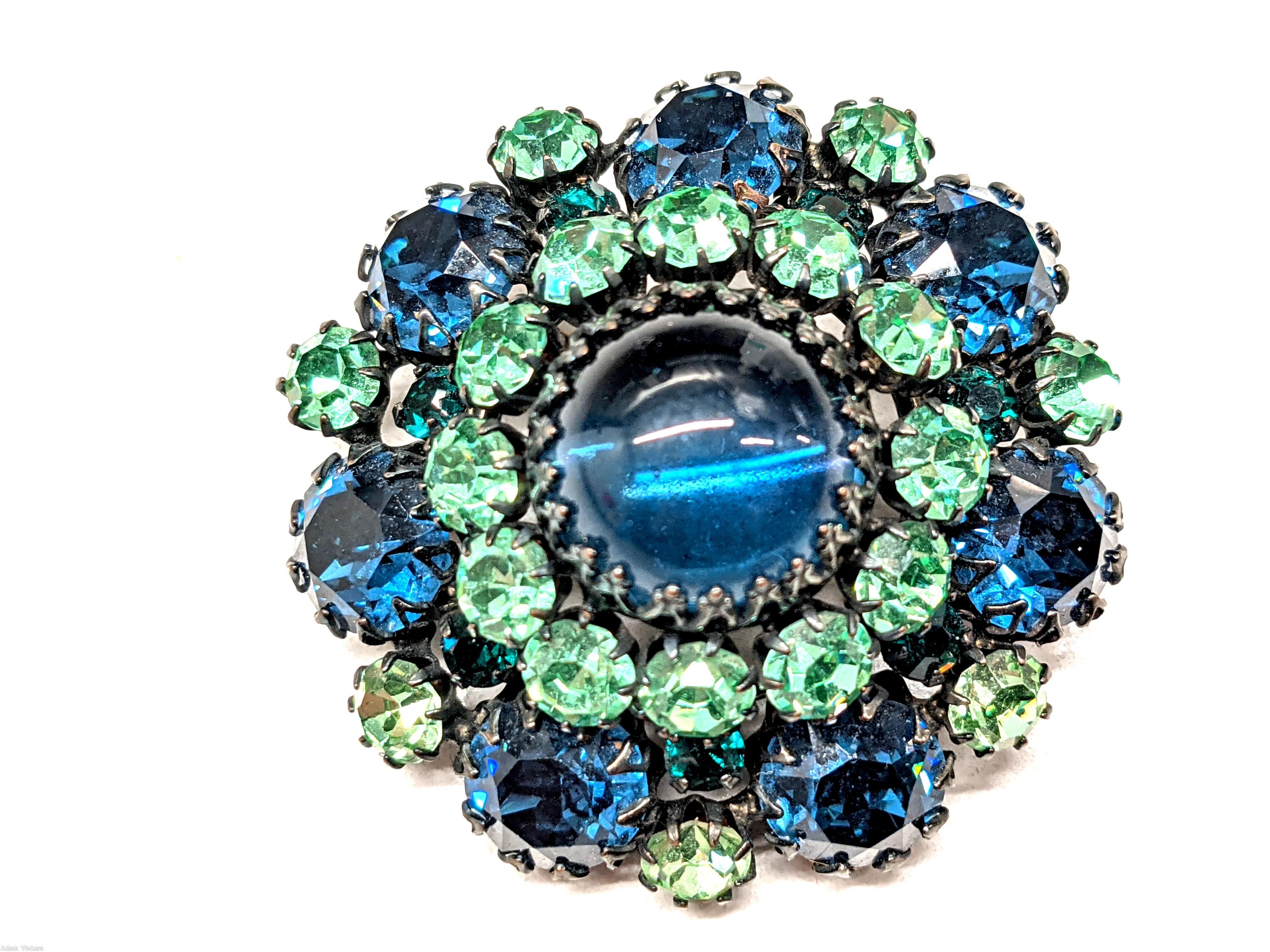 Schreiner round domed pin large round cab center 12 surrounding small chaton 7 large chaton large blue cab center green small chaton blue large chaton silvertone jewelry