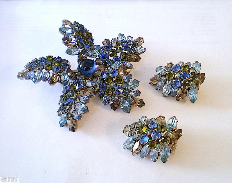Schreiner star shaped radical pin round cab center 5 surrounding bush like branch on stem small navette small chaton royal blue round cab center ice blue navette peridot small chaton smoky navette silvertone jewelry