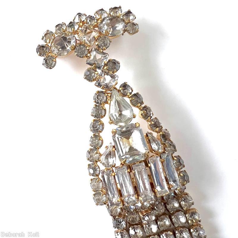 Schreiner top down long fringe pin top bar shape 2 large oval stone 12 surrounding small chaton middle triangle shape large teardrop large emerald cut center 5 baguette small chaton border 6 fringe of 9 chaton crystal goldtone jewelry
