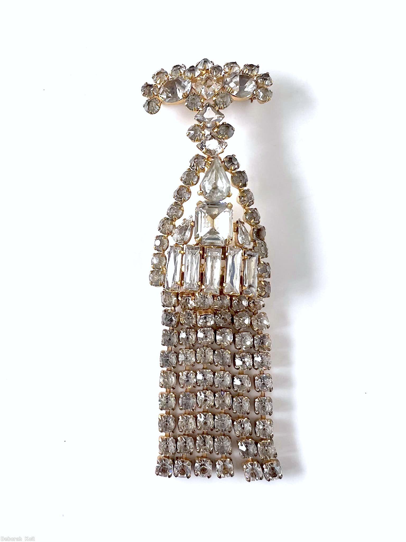 Schreiner top down long fringe pin top bar shape 2 large oval stone 12 surrounding small chaton middle triangle shape large teardrop large emerald cut center 5 baguette small chaton border 6 fringe of 9 chaton crystal goldtone jewelry