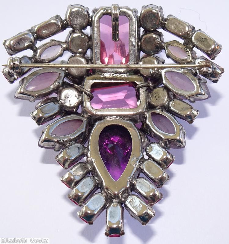 Schreiner triangle shaped 2 level domed radial pin top level large emerald cut center 12 surrounding baguette 4 navette bottom level large teardrop baguette navette wine large emerald cut purple large teardrop wine baguette moonglow lavender navette silvertone jewelry