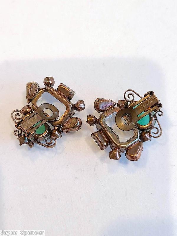 Schreiner asymmetrical scrollwork earring 1 large emerald cut 1 large oval cab 3 faux pearl 2 small teardrop 2 small chaton 1 small buguette large crystal faceted emeral cut marbled green large oval cab copper back jewelry