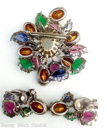 Schreiner 8 large carved leaf 4 small carved leaf sprawling 18 branch radial random arranged pin large oval center purple large carved leaf green large carved leaf navy large carve leaf peridot large oval facted stone crystal large oval faceted stone jewelry