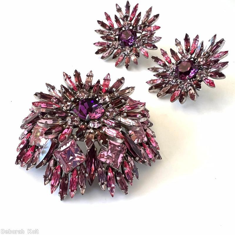 Schreiner round shaped flat top radial navette pin large chaton center 6 small square surrounding stone 6 navette surrounding stone 8 large square stone purple faceted large round stone center peach small square stone pink navette clear ice pink square stone lavender navette silvertone jewelry